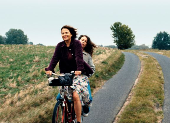 2 Frauen auf einem Fahrrad über Feldweg fahrend, Szene aus dem Film Miroirs No. 3